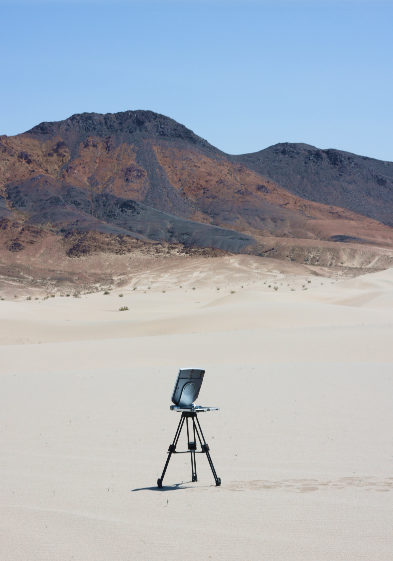 Satcube terminal in a desert with mountains